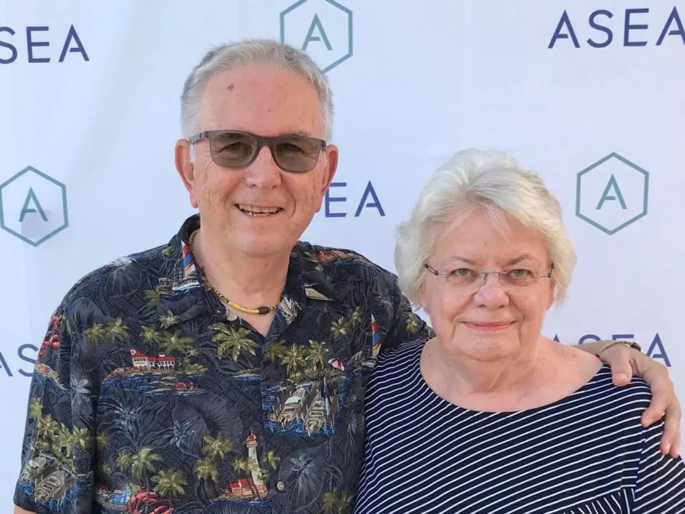 Asea Healing Tao Australia. Paula Loges standing next to her husband with a white background
